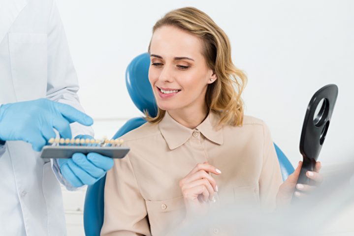 Arzt zeigt Patientin Zahnimplantate