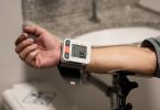 Arm mit einem Blutdruckmessgerät am Handgelenk